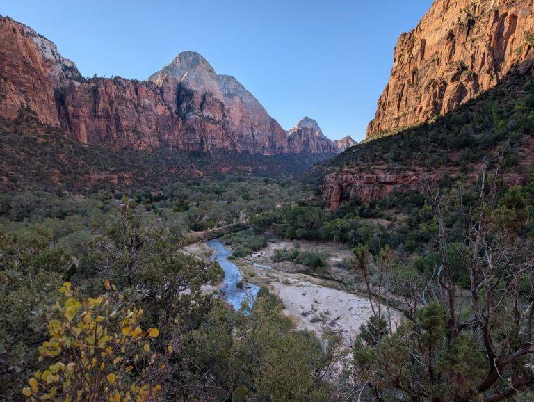 A view of Zion National Park from the Kayenta Trail. The Virgin River is in the middle and the canyons are on the left and right.