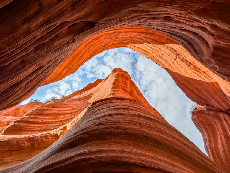 Picture of Peek A Boo Slot Canyon from the ground looking up to a blue sky